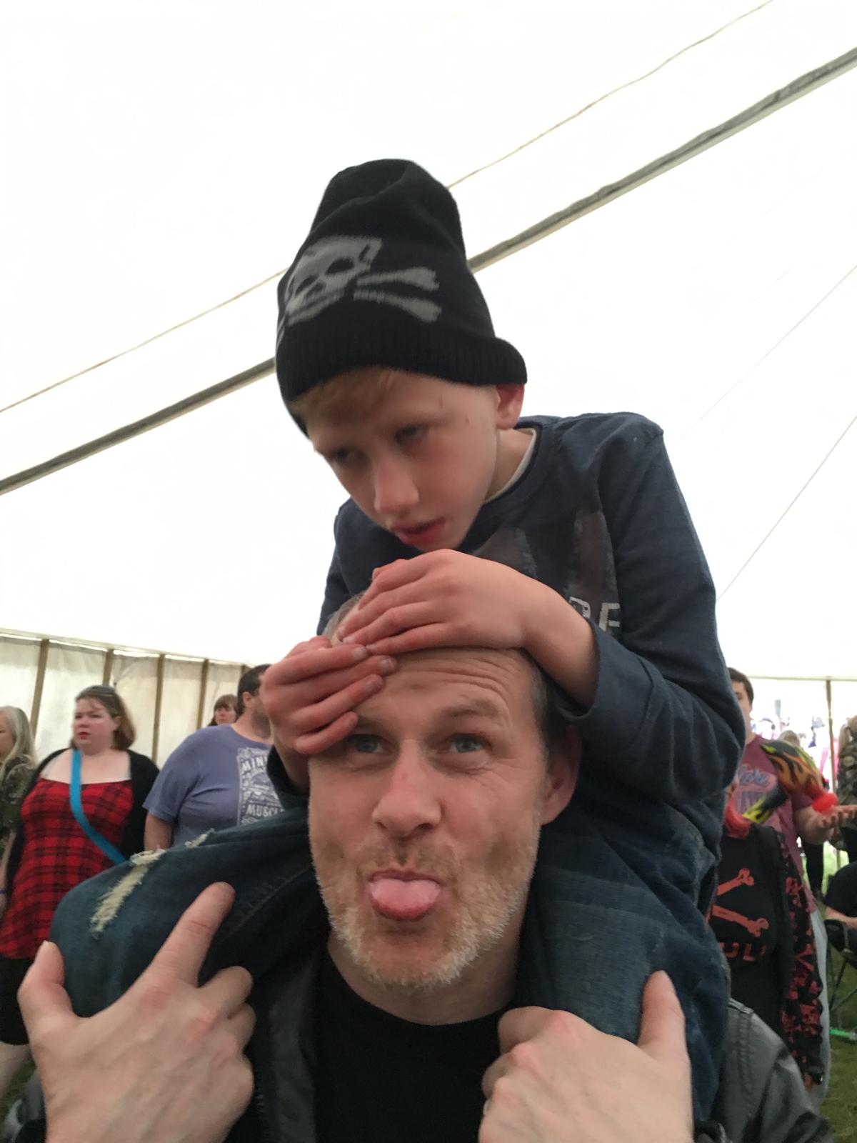 Finley on Carl's shoulders at a festival